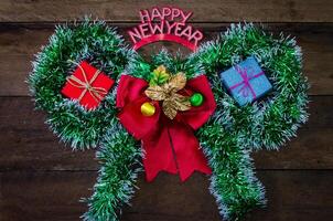 happy New Year message and gift box on wooden background. photo