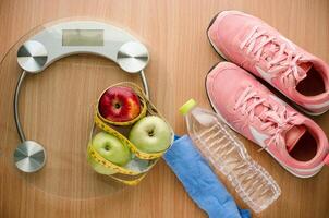 fitness concept with Exercise Equipment on wooden background. photo