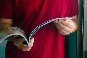 Man standing reading book image focus. photo