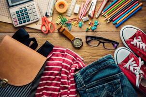 School supplies and costume placed on a wood background concept ready for school. photo