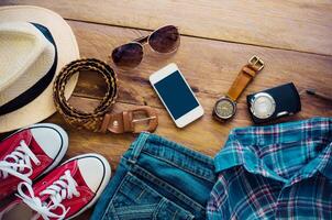 Travel accessories, clothes, wallet, glasses, phone, pasport, shoes, hat ready for travel photo