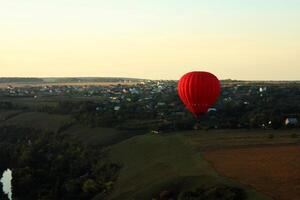 Hot air balloon over green fields photo