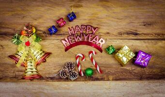 Happy New Year message and gift box on wooden background. photo