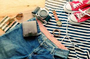 Travel accessories and costume on wooden floor photo