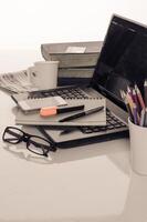 office desk with laptop with business accessories and cup of coffee photo