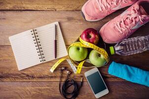 fitness concept with Exercise Equipment on wooden background. photo