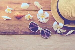 Travel accessories for summer on wooden background photo