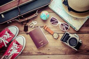 Travel accessories on wooden floor ready for travel photo