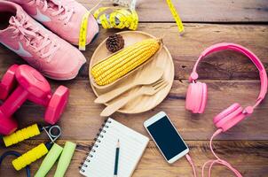 fitness concept with Exercise Equipment on wooden background. photo