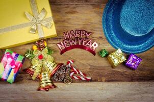 Happy New Year message and gift box on wooden background. photo