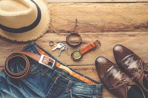 Clothing and accessories for men on wood floor photo