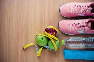 fitness concept with Exercise Equipment on wooden background. photo