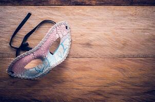 Fancy mask is placed on a wooden floor photo