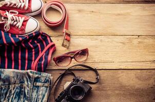 Travel accessories and costume on wooden floor photo