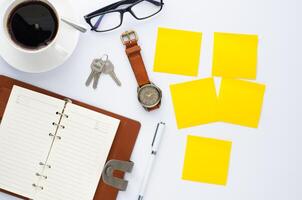 coffee cup, pen, notebook and accessory for work on white background photo