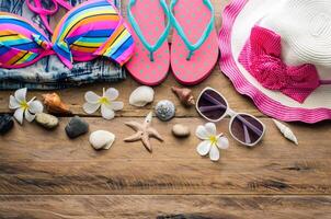 Beauty colorful bikini and accessories on wooden floor photo