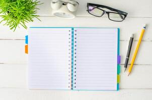 Notebook, pen, shoes, on white wooden floor. photo