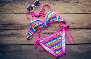 Beauty colorful bikini on wooden floor photo