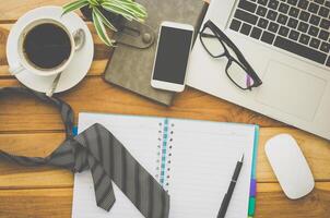 Laptop and cup coffee on wooden floor for work photo