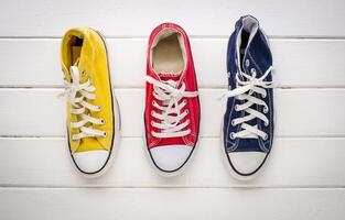 Multicolored sneakers on wood floor photo