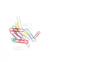 Colored paper clips on a white background. photo