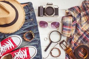 Travel accessories and costume on white background photo