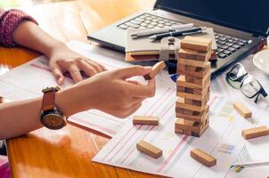 Business risks in the business. Requires planning Meditation must be careful in deciding to reduce the risk in the business. As the game drew to a wooden block from the tower photo