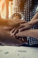 Concept of teamwork  Close-Up of hands business team showing unity with putting their hands together. photo