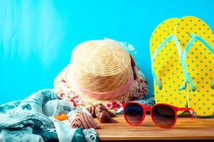 accessories for summer on wooden blue background photo