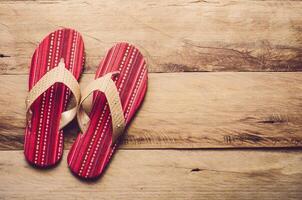 Red slipper on wooden photo