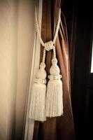 Curtains tied with white tassel. photo