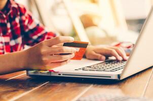 Woman holding credit cards and mobile phones are now shopping over the internet by paying by credit card. photo