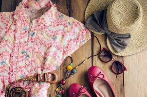 Clothing and accessories for women on wood floor for travel at holiday photo