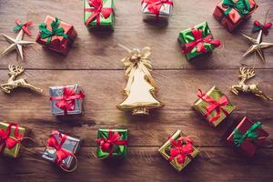 Top view of golden Christmas tree and many gift boxes placed on wooden floor. photo