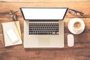 Top view with copy space, working desk with laptop,cellphone,notebook pencil and coffee in the office. photo