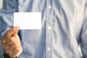 Close Up man holding white business card photo