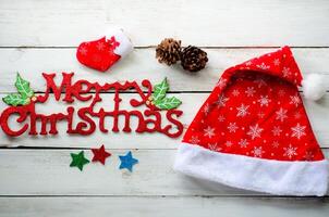 Christmas decorations and Merry christmas greetings on a wood white background. photo