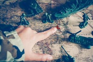 Blurred images of soldiers and tactical battle troops. But focus on world map goals. photo