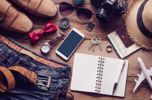 Travel accessories on wooden floor ready for travel photo