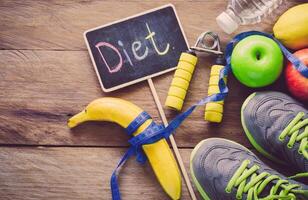 The concept of diet for weight loss  Exercise Equipment and word diet in wooden place photo