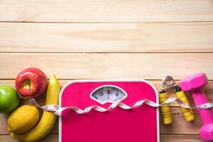 fitness concept with Exercise Equipment on wooden background. photo