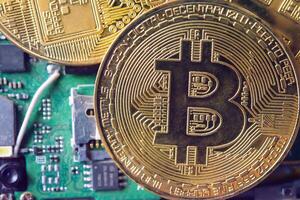 close-up bitcoin and its business-class laptop work and bring transactions across the network and help with today's business management, photo