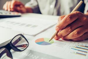 Business people are working on accounts in business analysis with graphs and documentation. photo