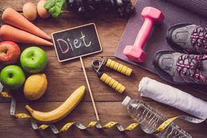 The concept of diet for weight loss  Exercise Equipment and word  diet  in wooden place photo