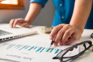 Business people are working on accounts in business analysis with graphs and documentation. photo