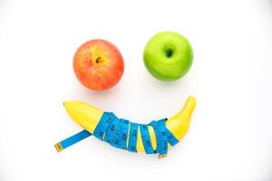 Bananas and measuring lines laid on white background - weight loss concept photo