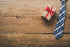 Father's Day Gift Ideas - Neckties and gift boxes are placed on wooden floor. photo