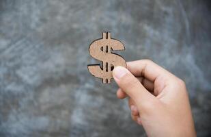 Hand Holding Dollar Signs - Concepts for Earning a Business photo