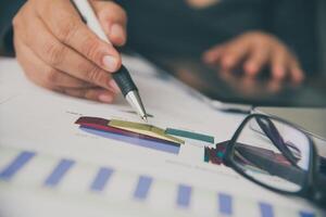 Business people are working on accounts in business analysis with graphs and documentation. photo