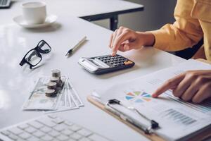Businesswoman a working on accounts in business analysis with graphs and documentation. photo
